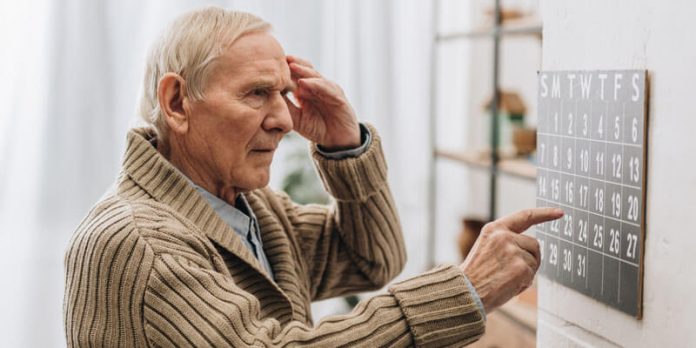 Senior Man Looking At Calendar